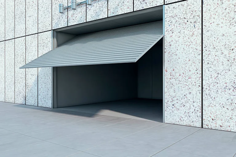 A sleek, partially open commercial garage door on a modern facade, showcasing ABX's innovative trackless system and energy-efficient operator designed for high-ROI industrial facilities.