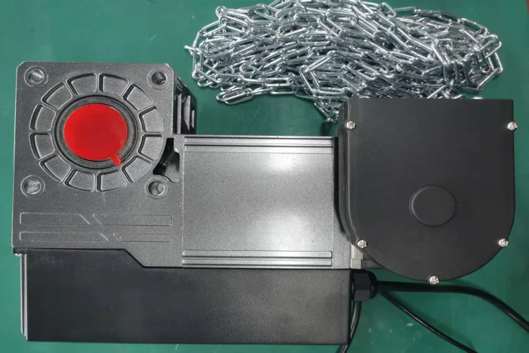 Close-up of an ABX heavy-duty commercial garage door operator motor equipped with a manual release chain, engineered for smart automation and zero reprogramming in industrial facilities.