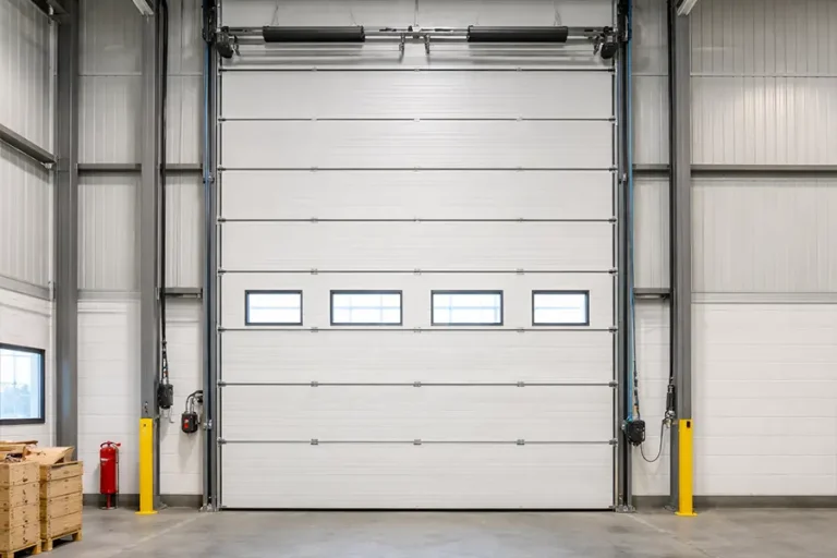  Internal view of a vertical lift garage door showcasing the heavy-duty industrial torsion spring counterbalance system.