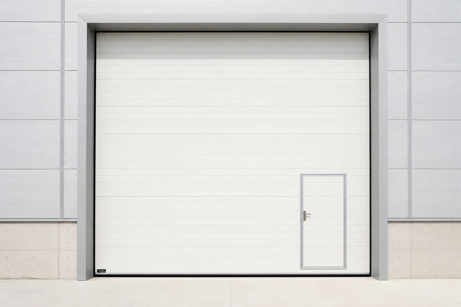 Blue industrial polyurethane insulated sectional door in a modern cold storage facility with conveyor rollers, stainless steel control panels, and clean white walls.