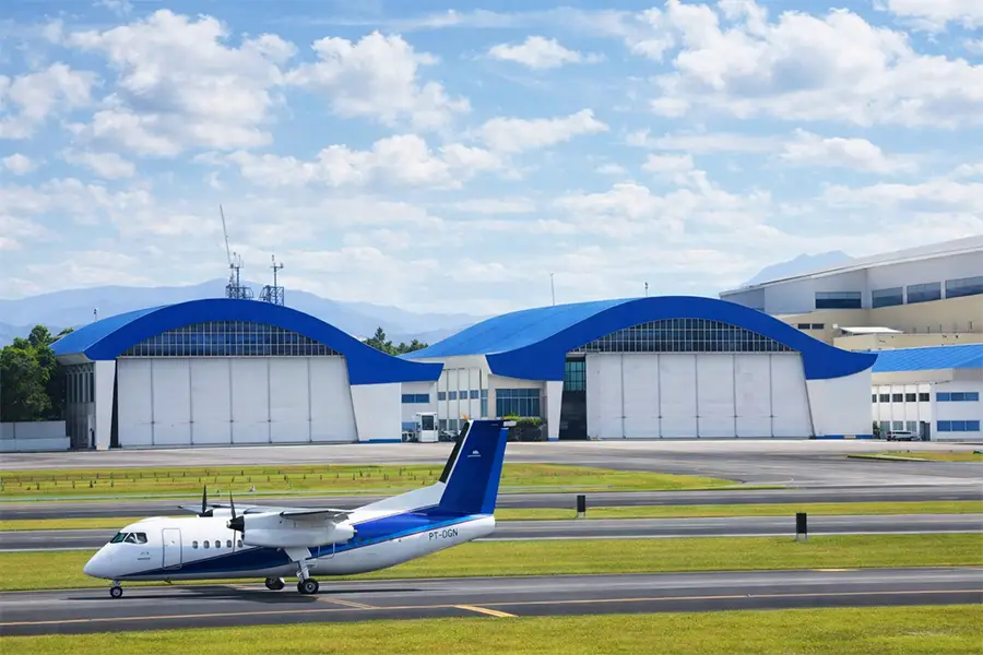Large-scale aircraft hangar door installation at a professional airport facility, showcasing industrial-grade engineering.