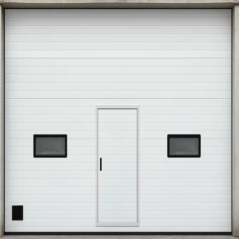 White industrial sectional overhead door with a pedestrian pass door and windows.