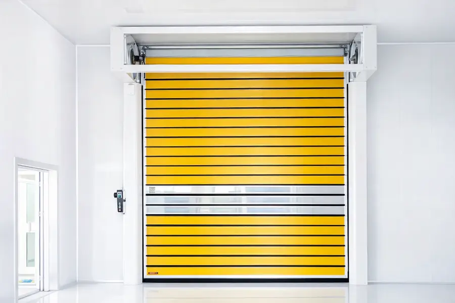 High-speed yellow spiral door with aluminum vision panels engineered for industrial cleanrooms and food processing.